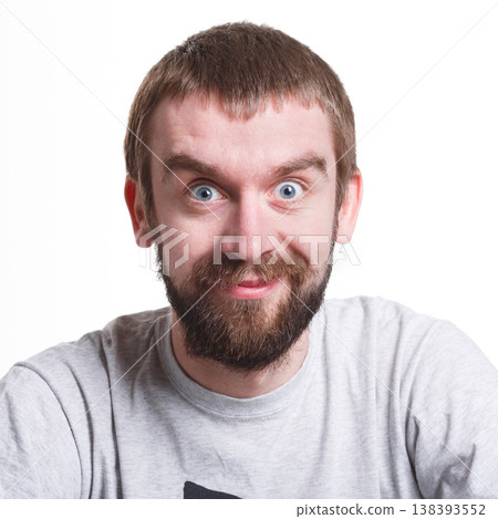 Pleasant news. Excited man expressing shock on face, smiling on white isolated studio background, portrait Pleasant news. Excited man expressing shock on face, smiling on white isolated studio background, portrait 138393552