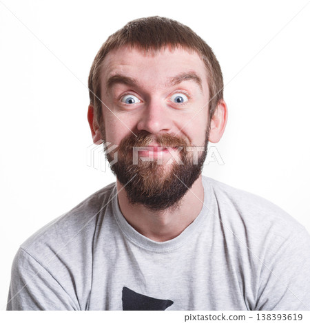 Pleasant news. Excited man expressing shock on face, smiling on white isolated studio background, portrait Pleasant news. Excited man expressing shock on face, smiling on white isolated studio background, portrait 138393619