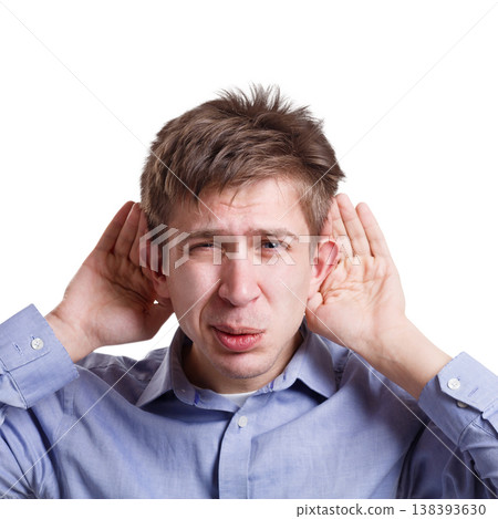 Man eavesdropping, holding hands near ears on white studio isolated background Man eavesdropping, holding hands near ears on white studio isolated background 138393630