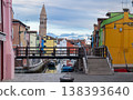 Colorful canal street with boats and bell tower 138393640