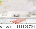 Clean kitchen counter with red checkered cloth in modern bright interior 138393704