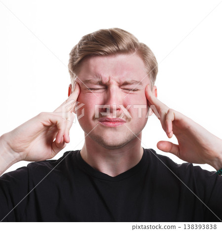 Under pressure. Concentrated tense stressed man, holding fingers on temple, white isolated studio background Under pressure. Concentrated tense stressed man, holding fingers on temple, white isolated studio background 138393838
