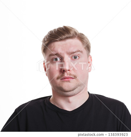 Feeling unpleasant surprised. Caucasian man grimacing to camera on white isolated background, studio shot, portrait 138393923
