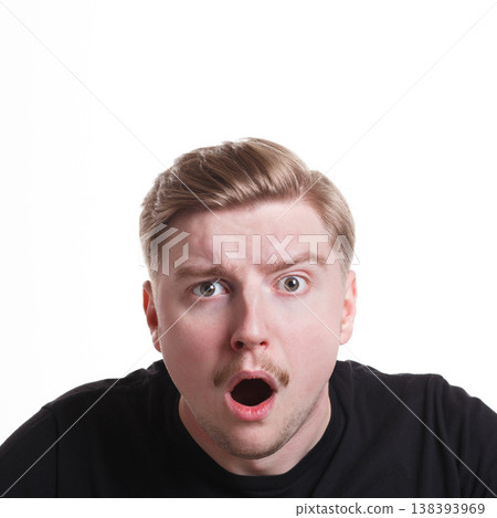 Shocking news. Wonder man expressing amaze on face, standing on white isolated background, studio shot Shocking news. Wonder man expressing amaze on face, standing on white isolated background, studio shot 138393969