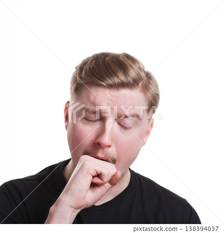 Sleepy yawning man standing on white isolated studio background. Facial expressions 138394037