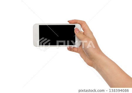 Female hand holding mobile phone display, cutout, white isolated background, copy space 138394086