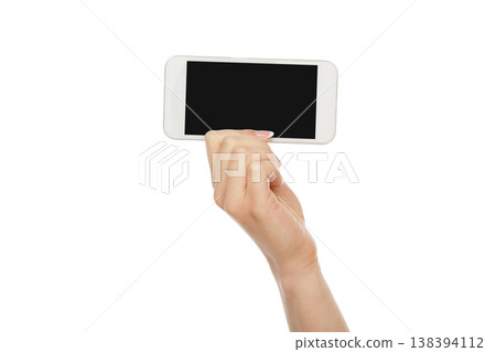 Female hand holding mobile phone isolated on white background, close-up, cutout, copy space on the screen 138394112