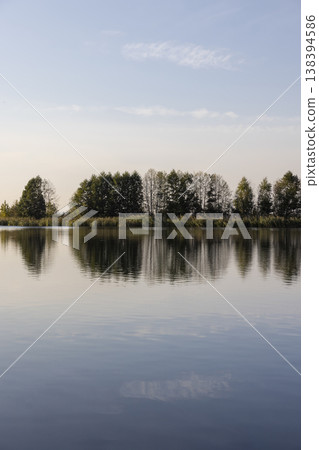 a lake in calm autumn weather at sunset, a wide lake with plants in the autumn at sunset a lake in calm autumn weather at sunset, a wide lake with plants in the autumn at sunset 138394586