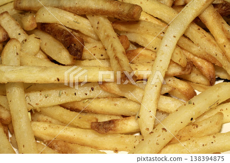Close up of golden french fries chips fried potatoes tasty junk food Close up of golden french fries chips fried potatoes tasty junk food 138394875