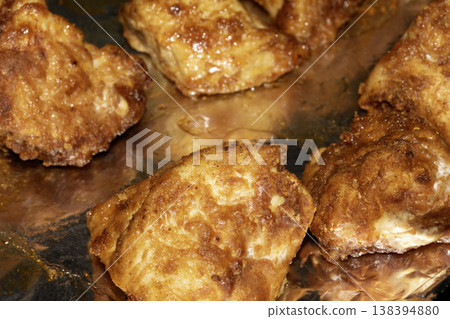 Close up of batterd deep fried golden chicken on foil Close up of batterd deep fried golden chicken on foil 138394880