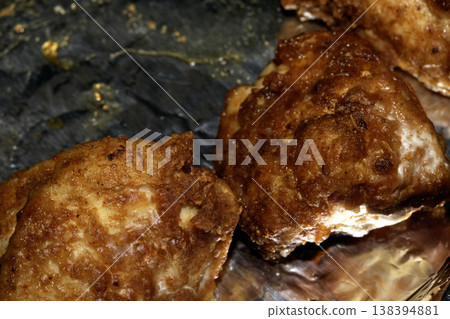 Close up of batterd deep fried golden chicken on foil 138394881
