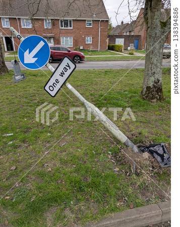 One way sign that a car has driven into a broken knocked over damaged traffic pole One way sign that a car has driven into a broken knocked over damaged traffic pole 138394886