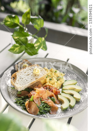 smoked salmon with avocado salad and scrambled eggs healthy breakfast plate in outdoor cafe smoked salmon with avocado salad and scrambled eggs healthy breakfast plate in outdoor cafe 138394921