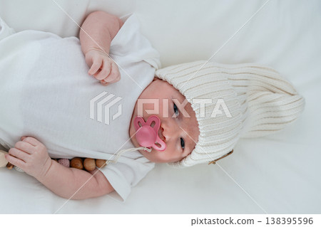 Detailed view of infant face resting on white pillow. Concept of newborn health, pediatric care, safe sleep and early development. 138395596