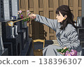一位女士正準備在墳墓上放鮮花。 138396307