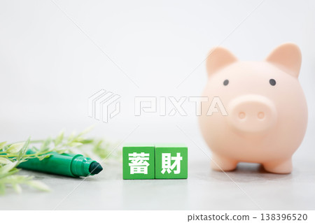 The image of saving money, represented by a piggy bank, a pen, and a houseplant. 138396520
