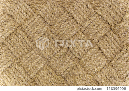 Natural sisal or coconut fiber carpet texture with coarse woven pattern. Close-up of durable organic floor covering material in warm golden brown tones for interior design Natural sisal or coconut fiber carpet texture with coarse woven pattern. Close-up of durable organic floor covering material in warm golden brown tones for interior design 138396906