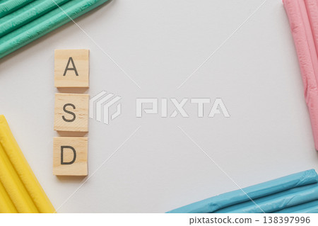 Top view photo of the ASD acronym in wooden tiles on a white background. Vibrant clay accents symbolize the autism spectrum, with ample copy space for medical or social content Top view photo of the ASD acronym in wooden tiles on a white background. Vibrant clay accents symbolize the autism spectrum, with ample copy space for medical or social content 138397996