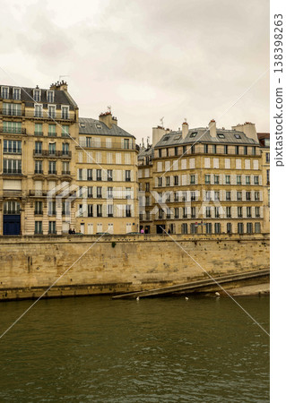 Haussmann architecture lining the Seine River embankment in Paris, France under an overcast sky 138398263