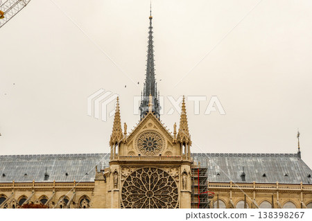 Notre Dame de Paris cathedral showcasing its ornate spires, flying buttresses, and a rose window during ongoing restoration in France 138398267