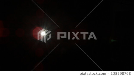 Abstract cinematic lens flare with bright light burst and star rays, isolated on black background. Optical light effect ideal for VFX overlays, transitions, titles and dramatic visual accents. Abstract cinematic lens flare with bright light burst and star rays, isolated on black background. Optical light effect ideal for VFX overlays, transitions, titles and dramatic visual accents. 138398768