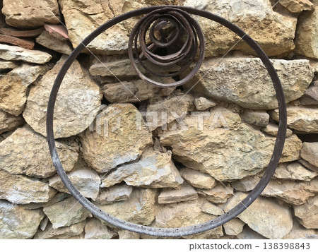 metal rings of various sizes on stone wall metal rings of various sizes on stone wall 138398843