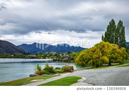 Lake Wanaka shoreline with mountains and trees Lake Wanaka shoreline with mountains and trees 138398926