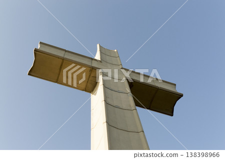 large concrete cross located at the top of the mountain 138398966