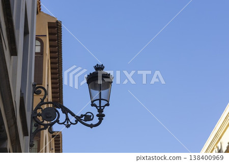 Elegant street lamp brightens a sunny afternoon in Malaga's charming streets Elegant street lamp brightens a sunny afternoon in Malaga's charming streets 138400969