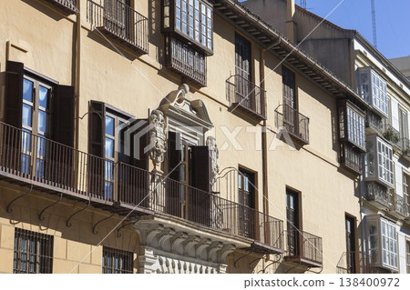 Historic architecture in sunny Malaga, Spain showcasing elegant balconies and intricate stonework Historic architecture in sunny Malaga, Spain showcasing elegant balconies and intricate stonework 138400972