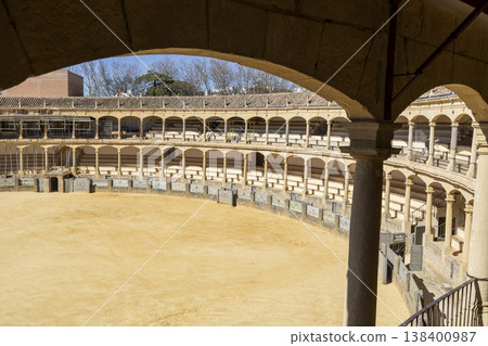 Plaza de Toros in Ronda shows empty arena with covered seating and clear sky on a sunny day Plaza de Toros in Ronda shows empty arena with covered seating and clear sky on a sunny day 138400987