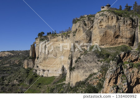 Visiting Ronda in Spain to see the cliffs and the scenic landscape in a clear sky Visiting Ronda in Spain to see the cliffs and the scenic landscape in a clear sky 138400992