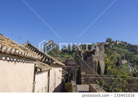 Exploring the historic Alkazaba in Malaga, Spain under a clear blue sky during the daytime Exploring the historic Alkazaba in Malaga, Spain under a clear blue sky during the daytime 138401016