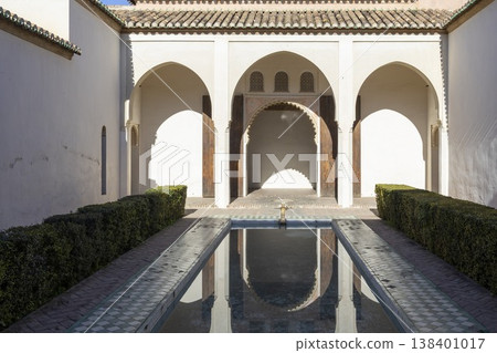 Visit Alkazaba in Malaga, Spain to explore the historical architecture and enjoy the garden area with water reflections and arches during daytime 138401017