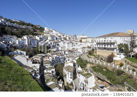 Exploring Setenil de las Bodegas, a unique village in Spain built into the rocks and hills under a clear blue sky 138401025