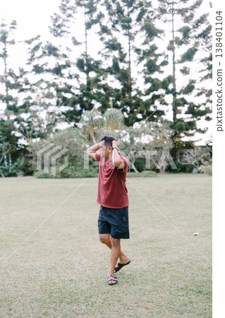 Curious man exploring open field with natural scenery Curious man exploring open field with natural scenery 138401104