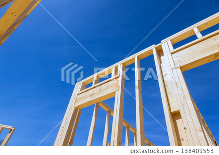 Workers are building wooden beams frame for new house structure while carpentry work framing job Workers are building wooden beams frame for new house structure while carpentry work framing job 138401553