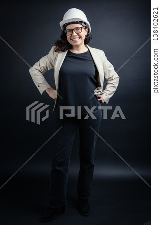 Confident woman engineer wearing hard hat smiling 138402621
