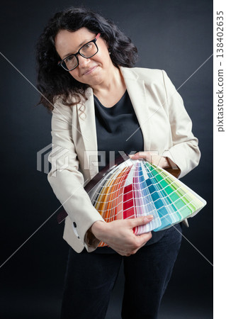 Woman holding color palette for design selection Woman holding color palette for design selection 138402635