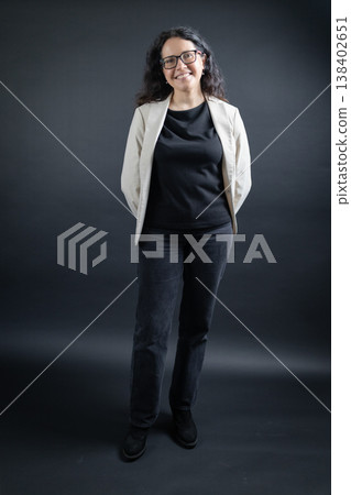 Professional woman standing smiling looking at camera Professional woman standing smiling looking at camera 138402651