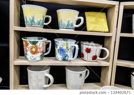 A variety of mugs featuring colorful flower motifs A variety of mugs featuring colorful flower motifs 138402671