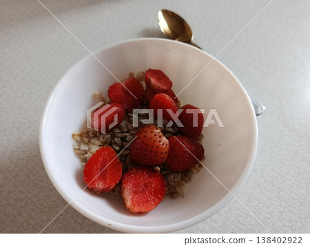 Healthy daily breakfast bowl presenting oats, sunflower seeds, and fresh cut strawberries, offering a nutritious and balanced meal option promoting wellness and diet awareness Healthy daily breakfast bowl presenting oats, sunflower seeds, and fresh cut strawberries, offering a nutritious and balanced meal option promoting wellness and diet awareness 138402922