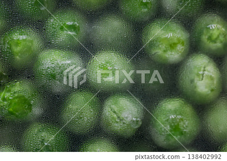 Macro shot of water droplets forming on green beans during the thawing process Macro shot of water droplets forming on green beans during the thawing process 138402992