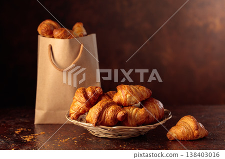 Fresh croissants on a brown vintage table. Fresh croissants on a brown vintage table. 138403016