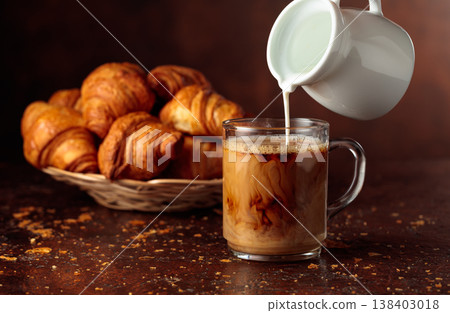 Coffee latte and croissants on a brown background. 138403018
