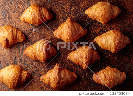 Fresh croissants on a brown vintage table. 138403024
