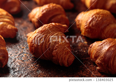 Croissants on a brown vintage background. Croissants on a brown vintage background. 138403025