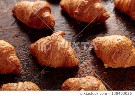 Croissants on a brown vintage background. Croissants on a brown vintage background. 138403026