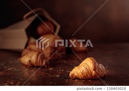 Fresh croissants on a brown vintage table. 138403028