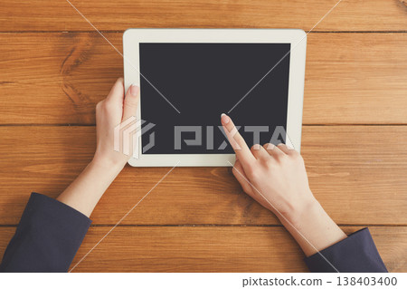 Female using digital tablet. Freelancer working with portable computer, copy space on display, top view, close up Female using digital tablet. Freelancer working with portable computer, copy space on display, top view, close up 138403400